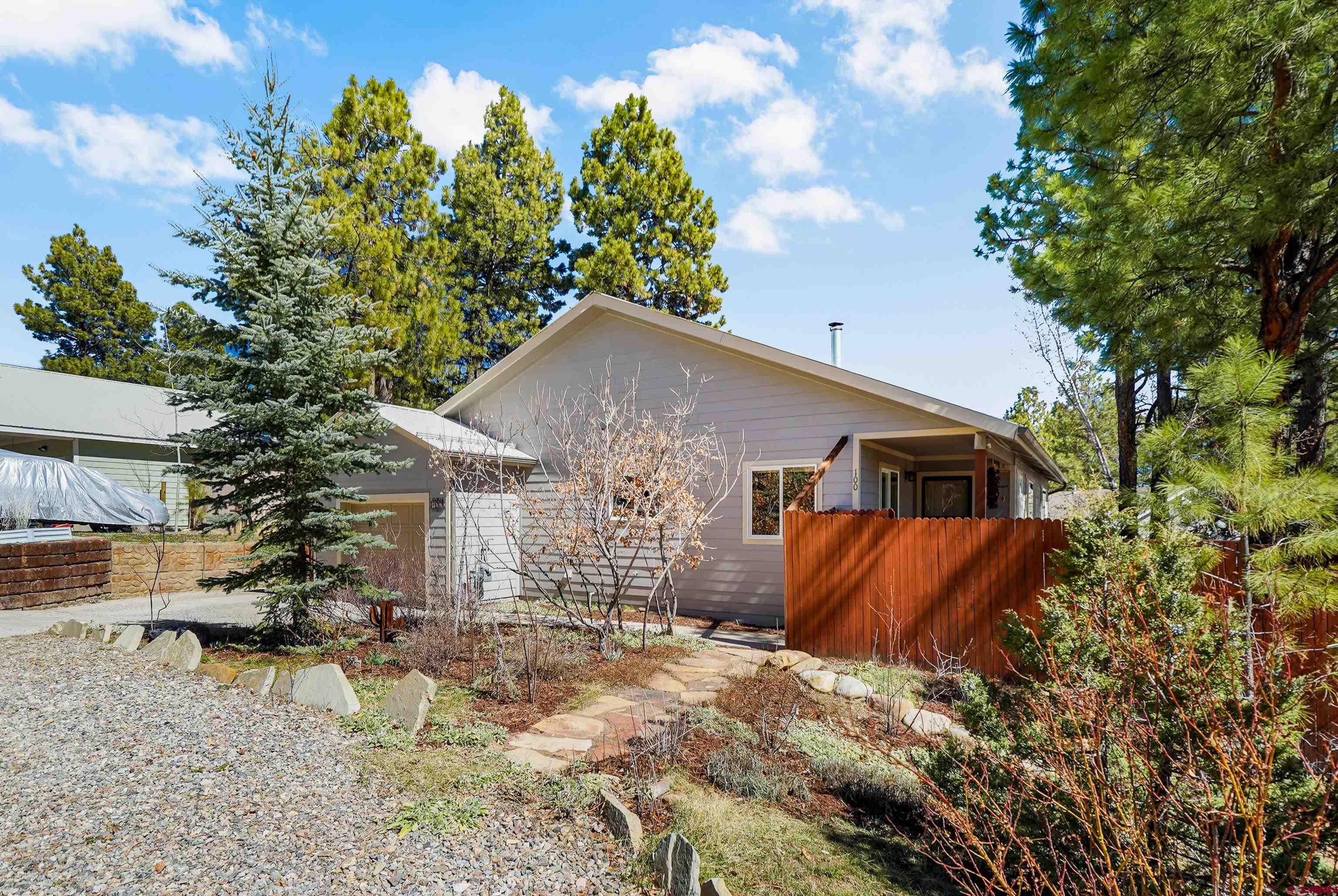 100 Westridge Road Durango, CO 81303 - Photo 38 of 39 a backyard of a house with table and chairs