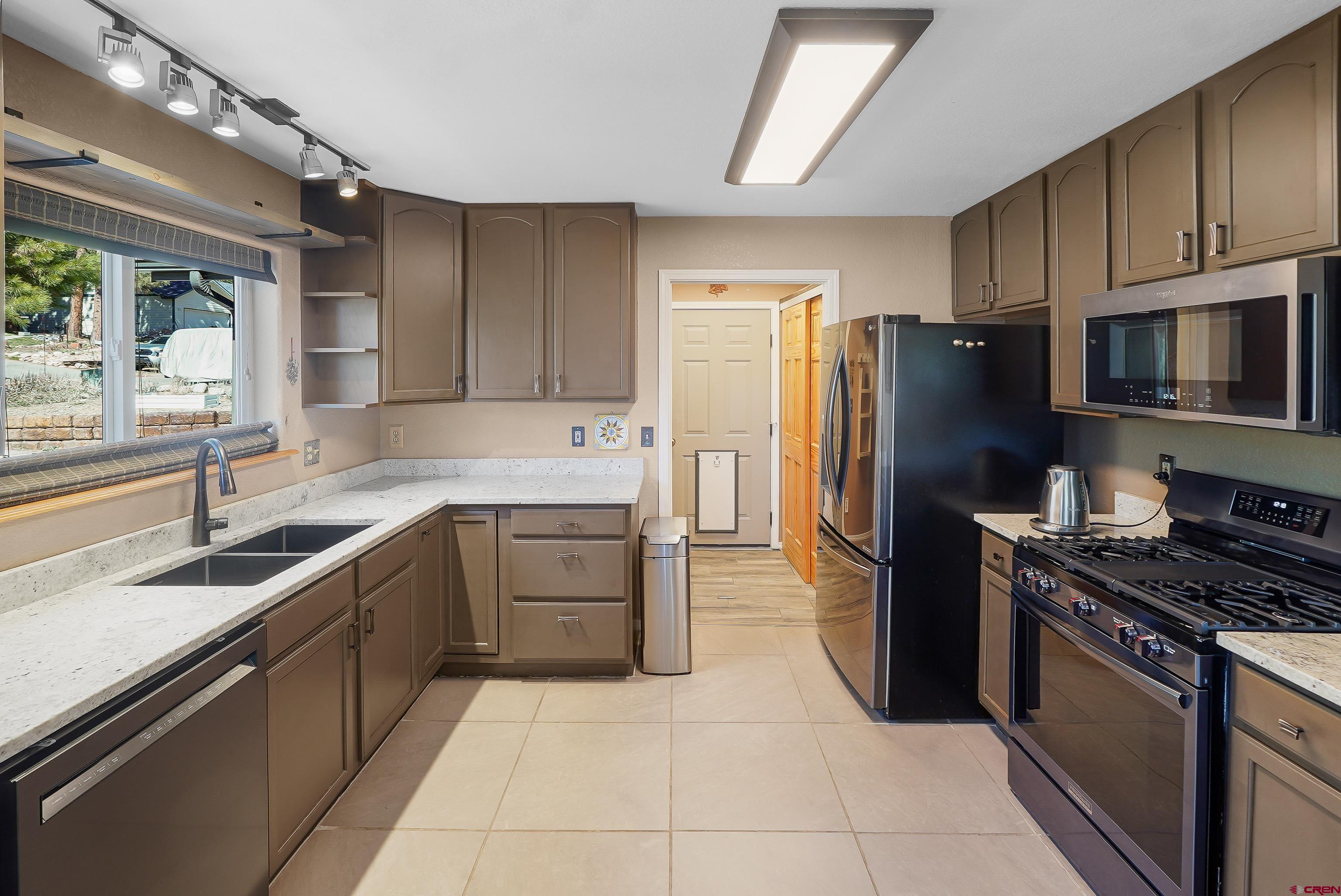 100 Westridge Road Durango, CO 81303 - Photo 10 of 39 a kitchen with a refrigerator sink and microwave