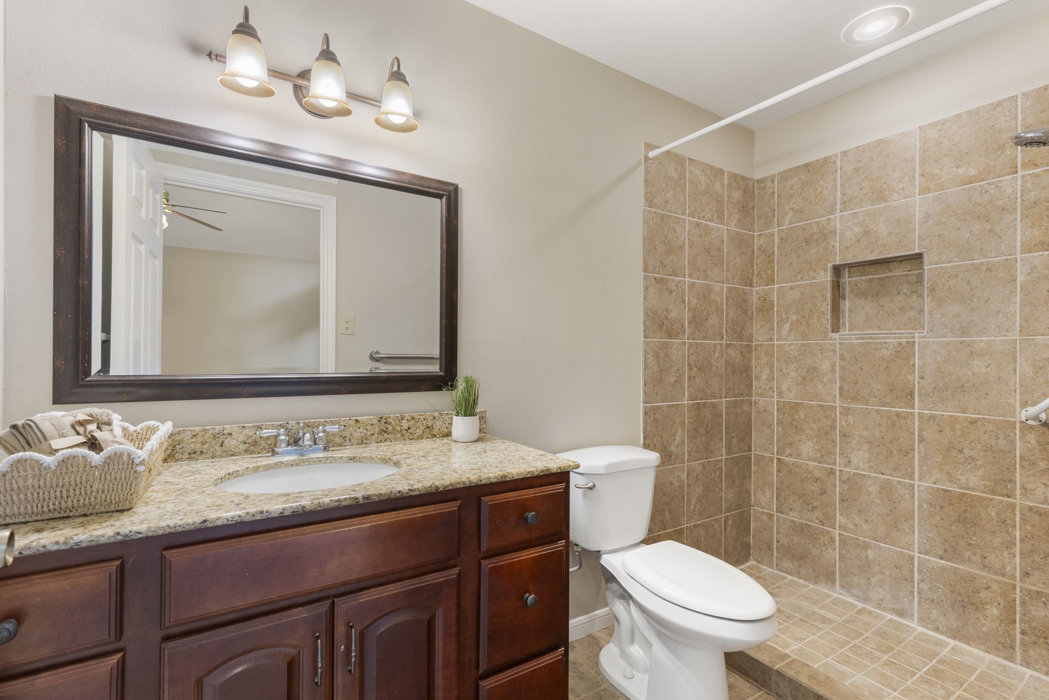 49 April Village Conroe, TX 77356 - Photo 24 of 46 a bathroom with a sink a toilet and a mirror