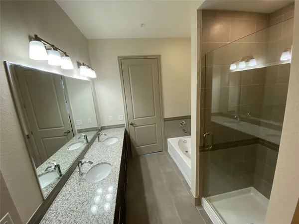a bathroom with a double vanity sink and mirror