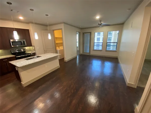 a view of a room with wooden floor and window