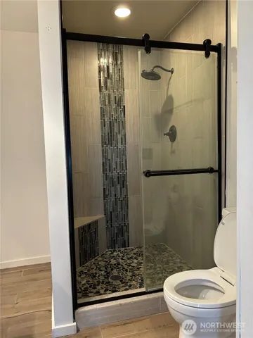 a bathroom with a toilet and a shower