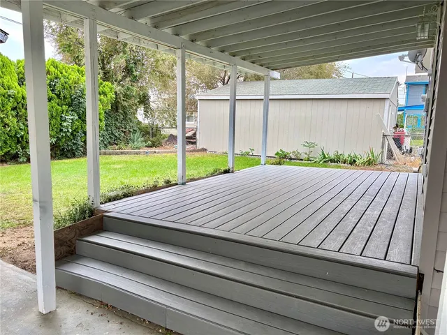 a view of a backyard with sitting area