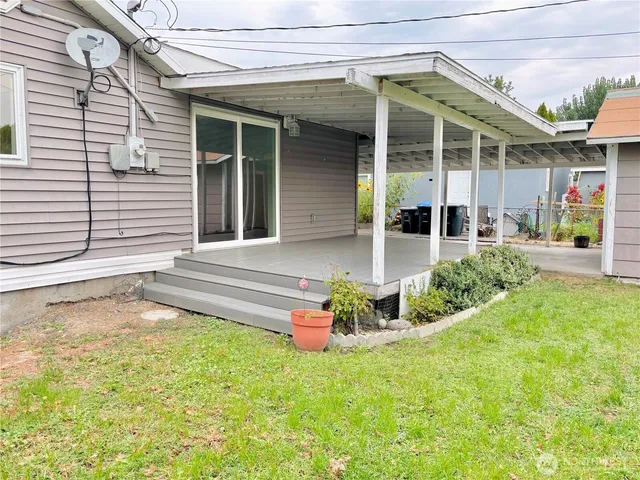 a front view of a house with a yard outdoor seating and garage