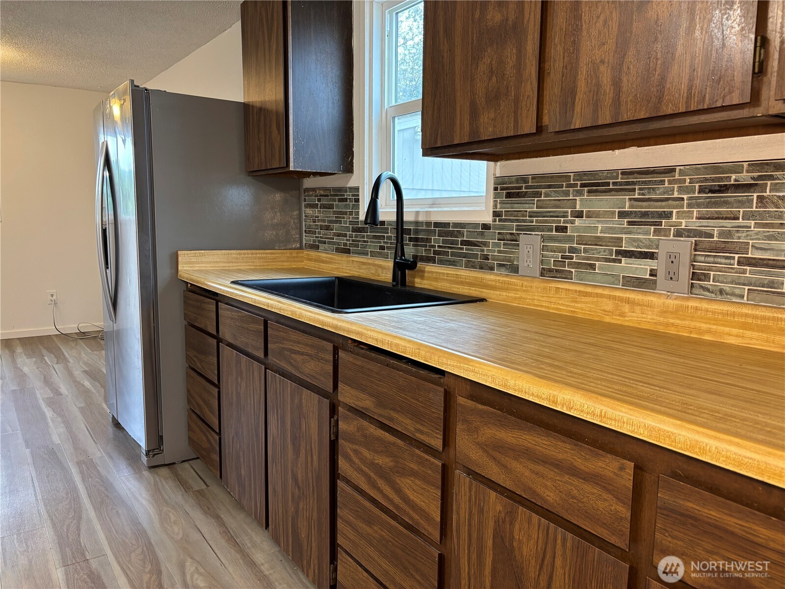 2207 West Spruce Street Moses Lake, WA 98837 - Photo 10 of 18 a kitchen with stainless steel appliances granite countertop a sink and wooden cabinets