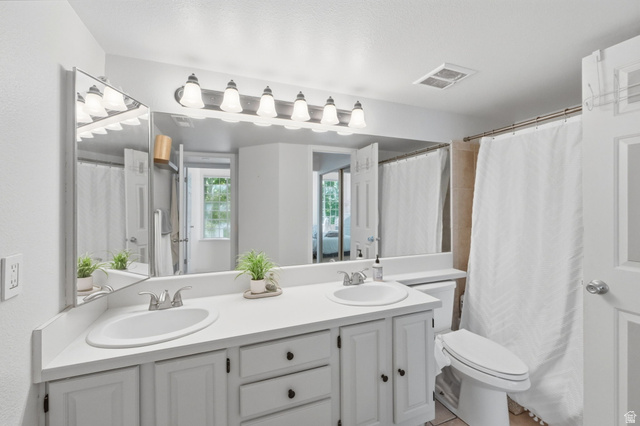 650 South Main Street, Unit 3304 Bountiful, UT 84010 - Photo 16 of 22 Bathroom featuring a dual-sink vanity with white cabinetry and a full-width mirror