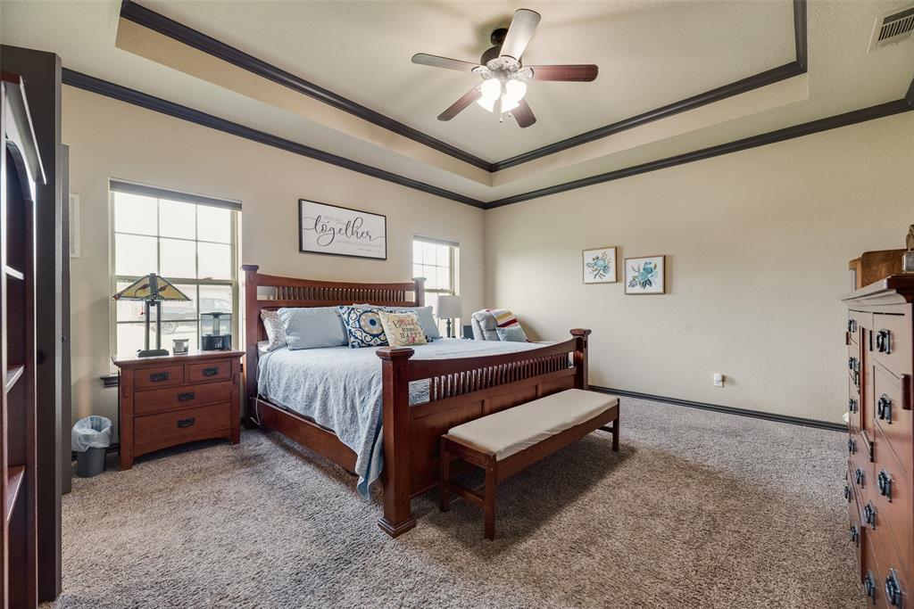 1132 Chartres Street Kaufman, TX 75142 - Photo 11 of 25 Spacious room featuring a tray ceiling with dark trim, recessed lighting, and a ceiling fan