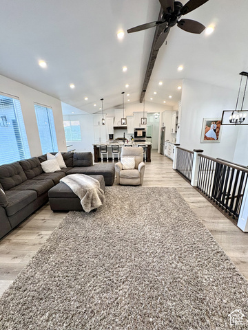 244 East Sevier River Road Central Valley, UT 84754 - Photo 20 of 66 Vaulted ceiling with exposed beam, recessed lighting, wood-finish flooring, white kitchen cabinetry, and dark kitchen island with pendant lighting