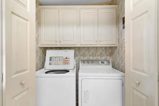 a view of walk in closet with clothes