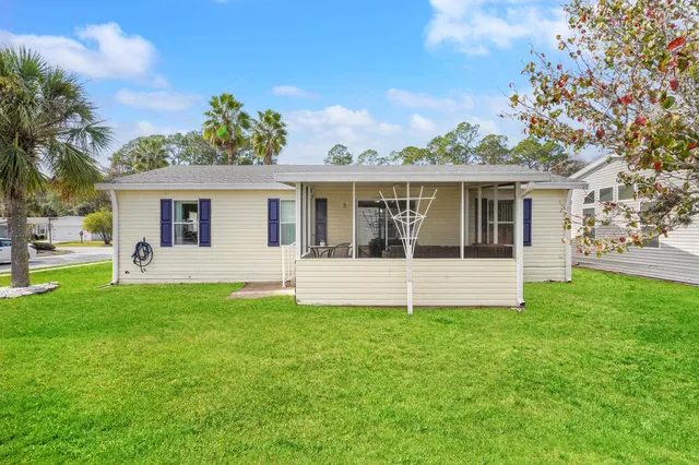 a view of house with a yard