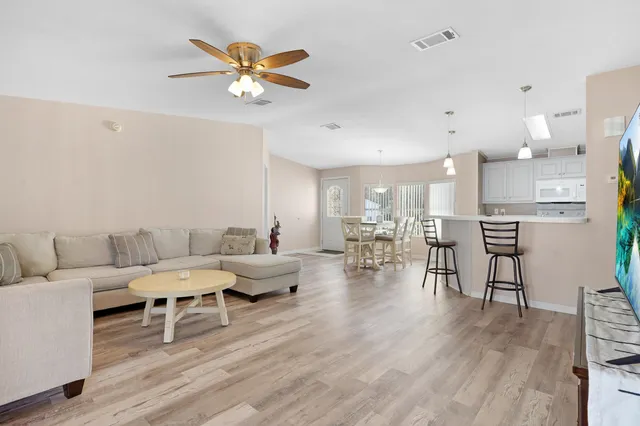 a living room with furniture a window and a flat screen tv