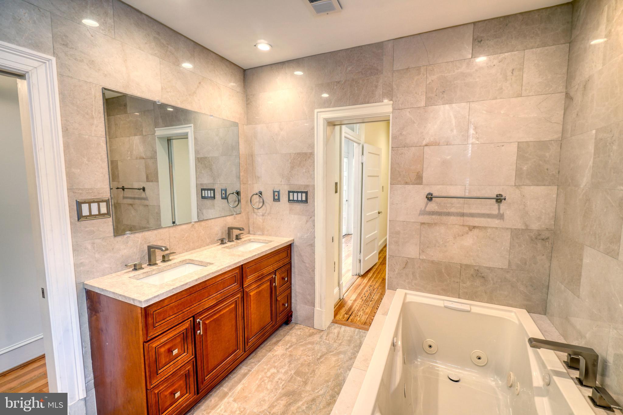 1821 Kilbourne Place Northwest Washington, DC 20010 - Photo 18 of 40 a bathroom with a tub sink and mirror