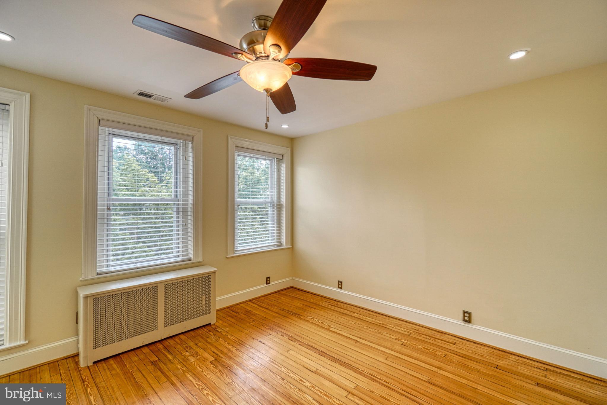 1821 Kilbourne Place Northwest Washington, DC 20010 - Photo 22 of 40 a view of an empty room with wooden floor and a window