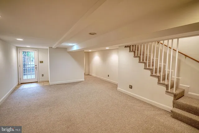 a view of a living room and a kitchen with furniture