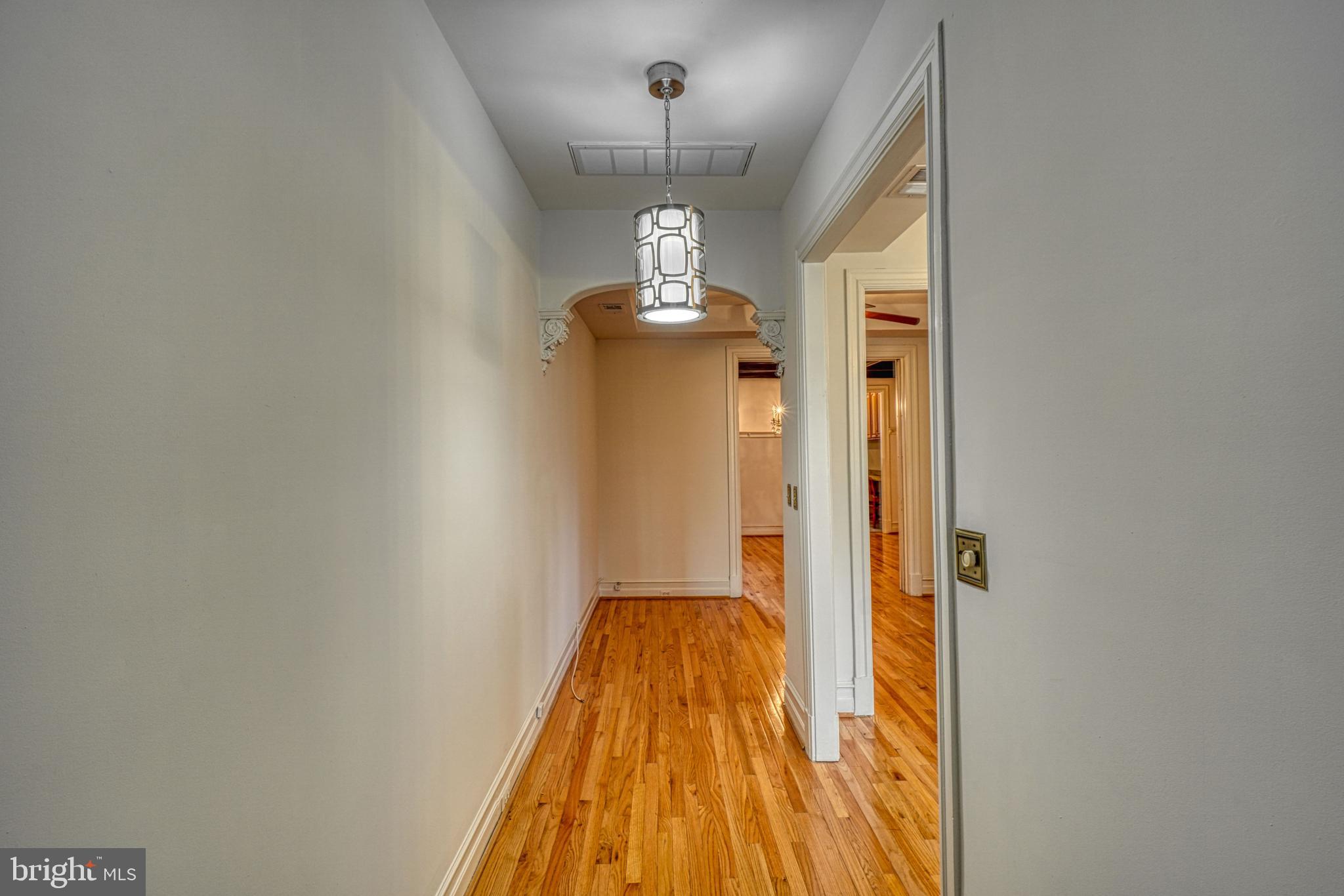 1821 Kilbourne Place Northwest Washington, DC 20010 - Photo 6 of 40 a view of a hallway with wooden floor and chandelier