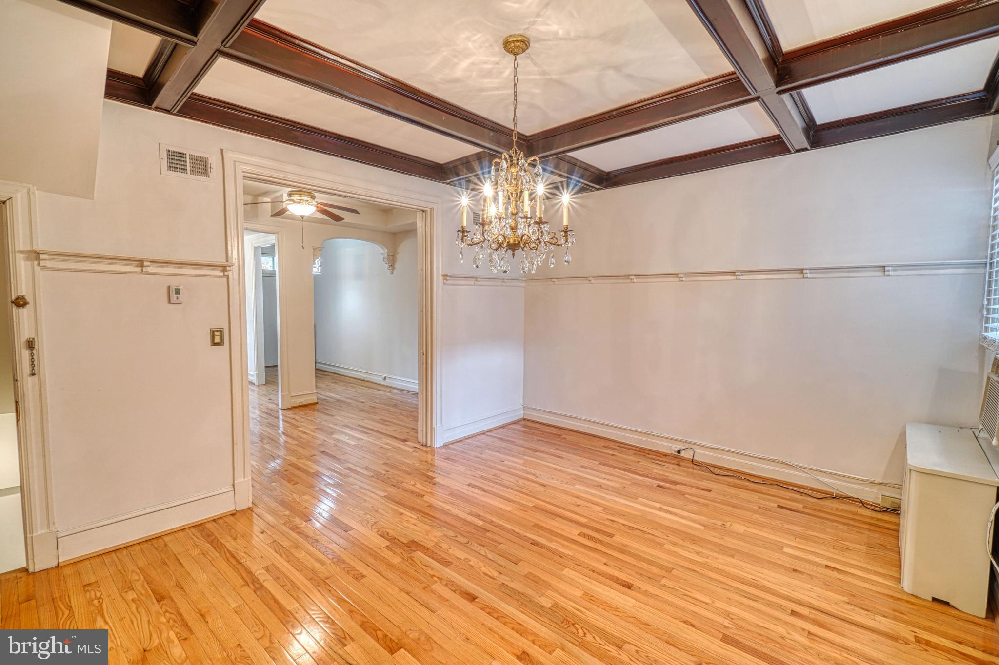 1821 Kilbourne Place Northwest Washington, DC 20010 - Photo 10 of 40 a view of a hallway with wooden floor and chandelier