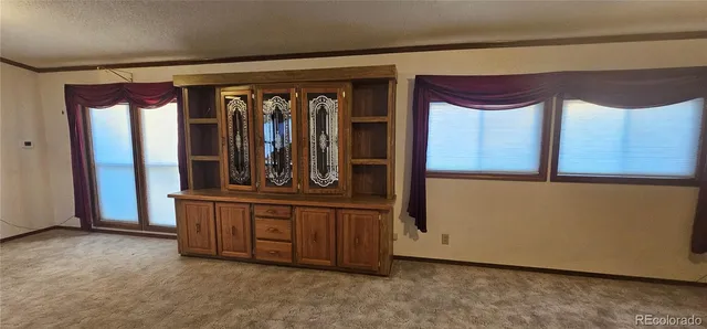 a view of an empty room with empty shelves