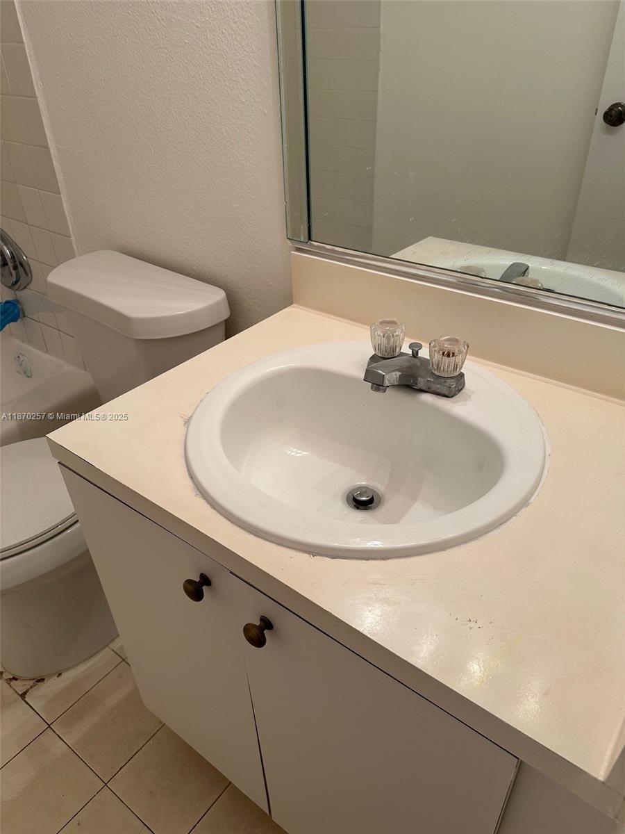 17911 Northwest 68th Avenue, Unit N206 Hialeah, FL 33015 - Photo 3 of 10 a bathroom with a sink and a toilet
