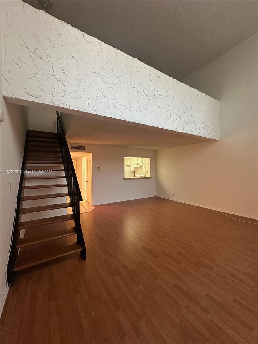 17911 Northwest 68th Avenue, Unit N206 Hialeah, FL 33015 - Photo 8 of 10 a view of an empty room with wooden floor