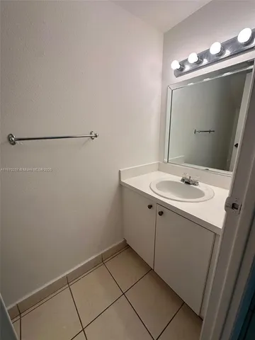 a bathroom with a sink vanity and a mirror