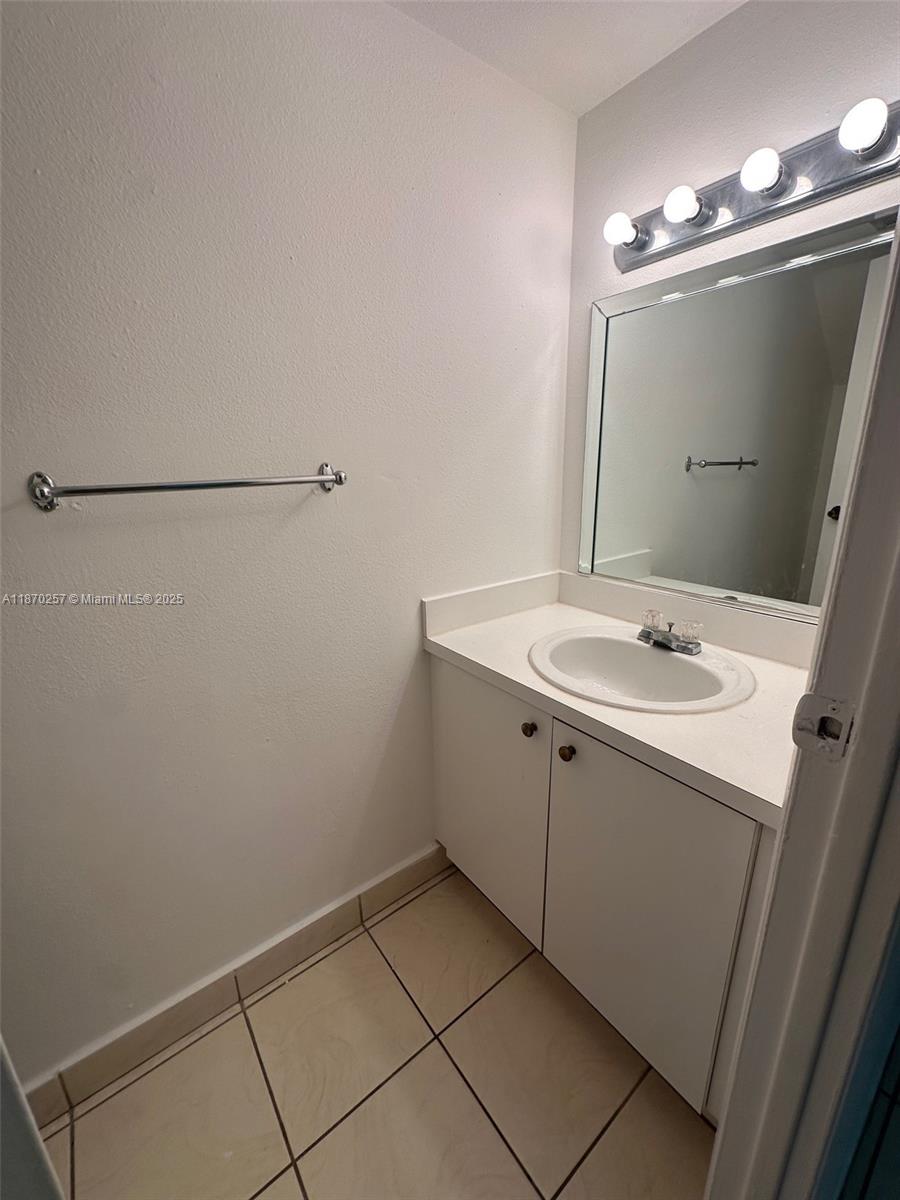 17911 Northwest 68th Avenue, Unit N206 Hialeah, FL 33015 - Photo 10 of 10 a bathroom with a sink vanity and a mirror
