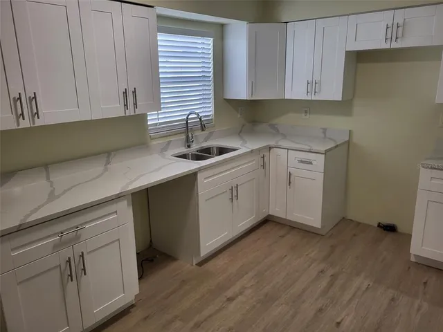 a kitchen with a sink cabinets and window