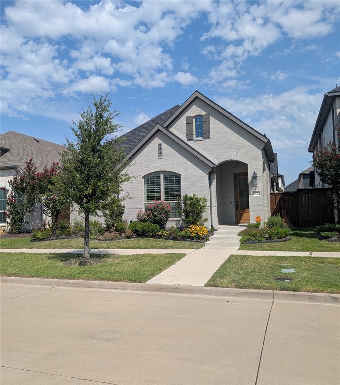 15532 Fringe Tree Road Frisco, TX 75035 - Photo 18 of 31 Light-colored brick exterior featuring an arched entryway and dark trim accents