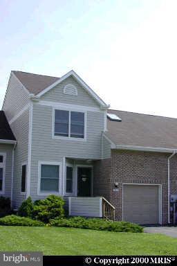 7012 Bridgepointe Drive, Unit 52 Chester, MD 21619 - Photo 1 of 12 a front view of a house with a yard and garage