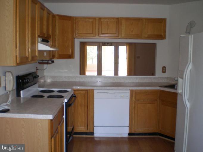 7012 Bridgepointe Drive, Unit 52 Chester, MD 21619 - Photo 2 of 12 a kitchen with a sink a stove and a refrigerator