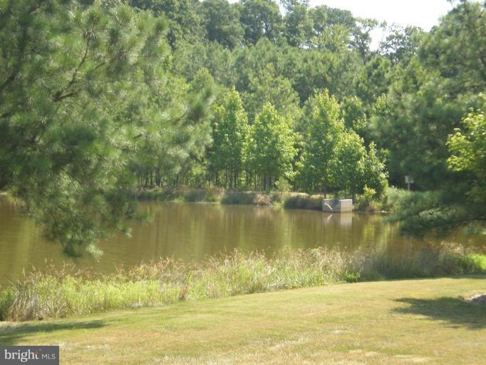 7012 Bridgepointe Drive, Unit 52 Chester, MD 21619 - Photo 12 of 12 a view of a lake with a yard