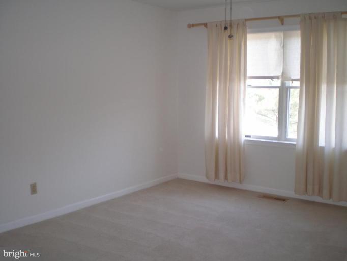7012 Bridgepointe Drive, Unit 52 Chester, MD 21619 - Photo 8 of 12 an empty room with a window