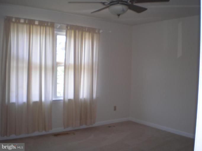 7012 Bridgepointe Drive, Unit 52 Chester, MD 21619 - Photo 9 of 12 a view of an empty room and window