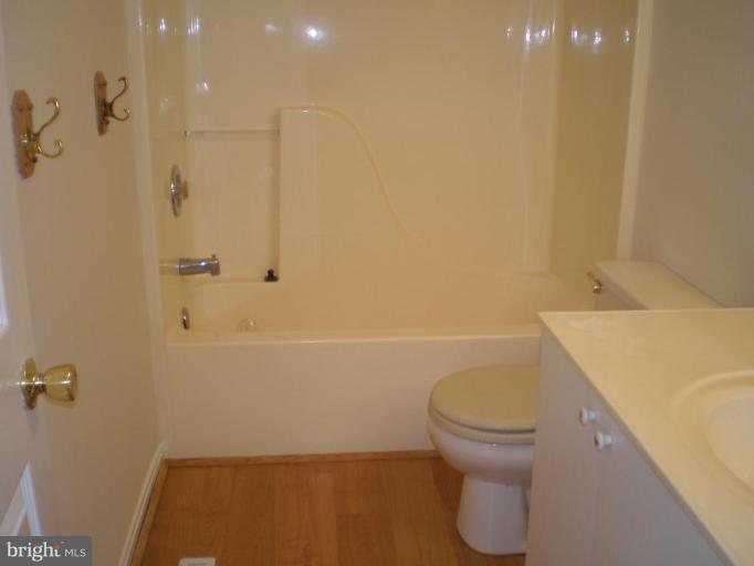 7012 Bridgepointe Drive, Unit 52 Chester, MD 21619 - Photo 10 of 12 a bathroom with a sink a toilet and shower