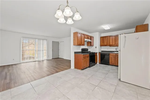 a kitchen with stainless steel appliances granite countertop a stove sink and cabinets