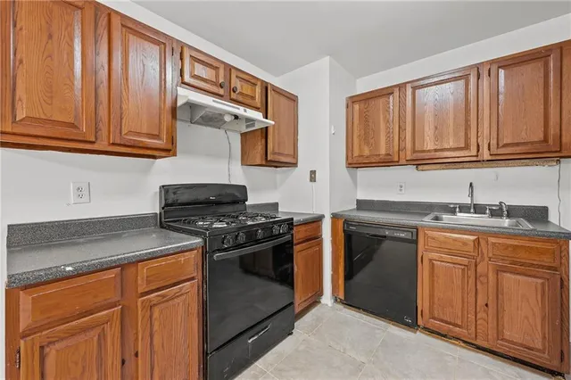 a kitchen with stainless steel appliances granite countertop a stove and a microwave
