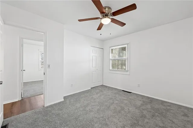 a view of a house with a yard and tree