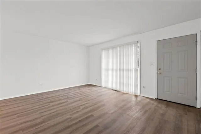 wooden floor in an empty room with a window