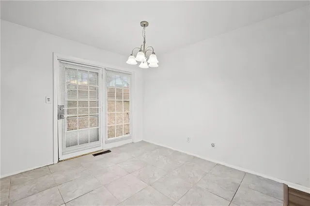a view of kitchen with granite countertop cabinets and refrigerator