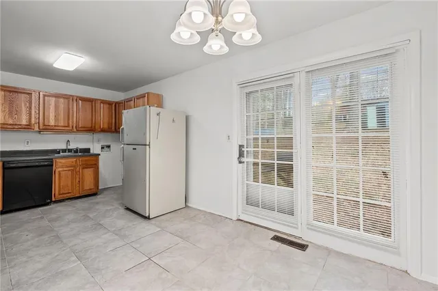 a kitchen with stainless steel appliances granite countertop a stove top oven a refrigerator a sink and dishwasher