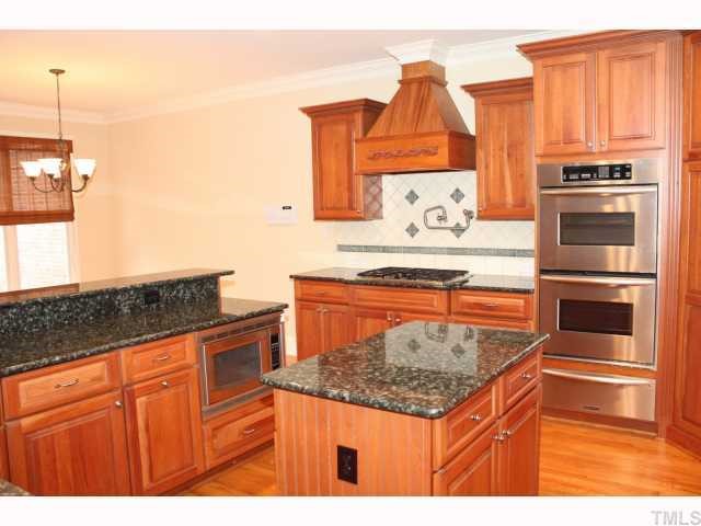 1821 Middlebrook Drive Raleigh, NC 27615 - Photo 3 of 12 a kitchen with stainless steel appliances granite countertop a stove a sink and a microwave