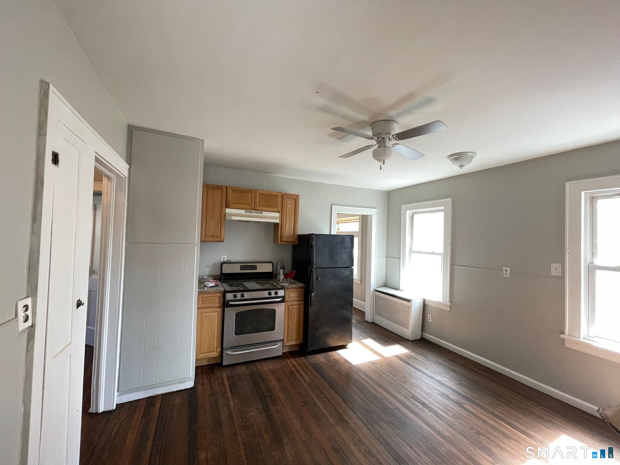 67 Kent Avenue Bridgeport, CT 06610 - Photo 7 of 11 a view of a kitchen with a stove cabinets and wooden floor