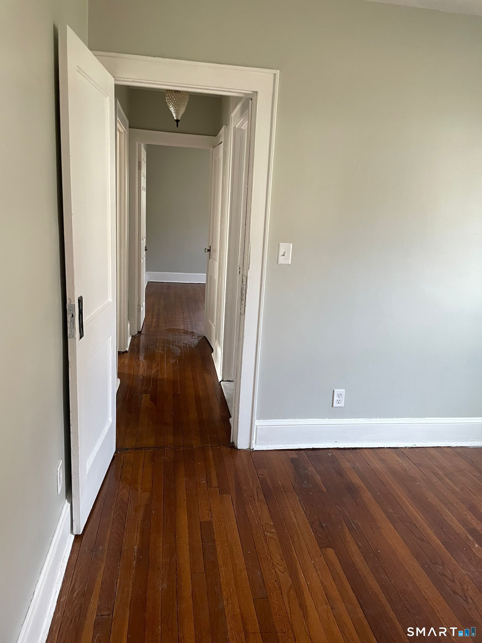 67 Kent Avenue Bridgeport, CT 06610 - Photo 10 of 11 a view of a hallway with wooden floor and a bathroom