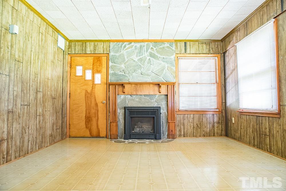 2900 Dink Ashley Road Timberlake, NC 27583 - Photo 6 of 15 a view of an empty room with a fireplace and a window