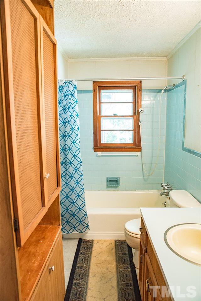 2900 Dink Ashley Road Timberlake, NC 27583 - Photo 7 of 15 a bathroom with a sink a bathtub a mirror and a shower
