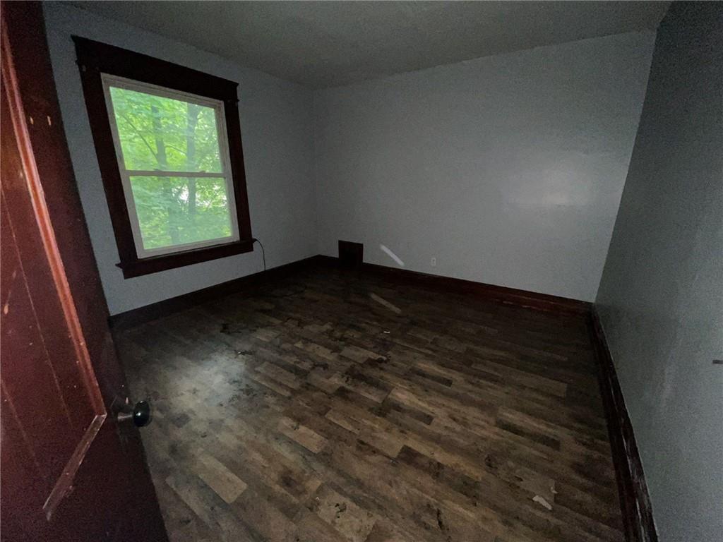 425 East Reynolds Street New Castle, PA 16101 - Photo 9 of 13 a view of an empty room with wooden floor and a window