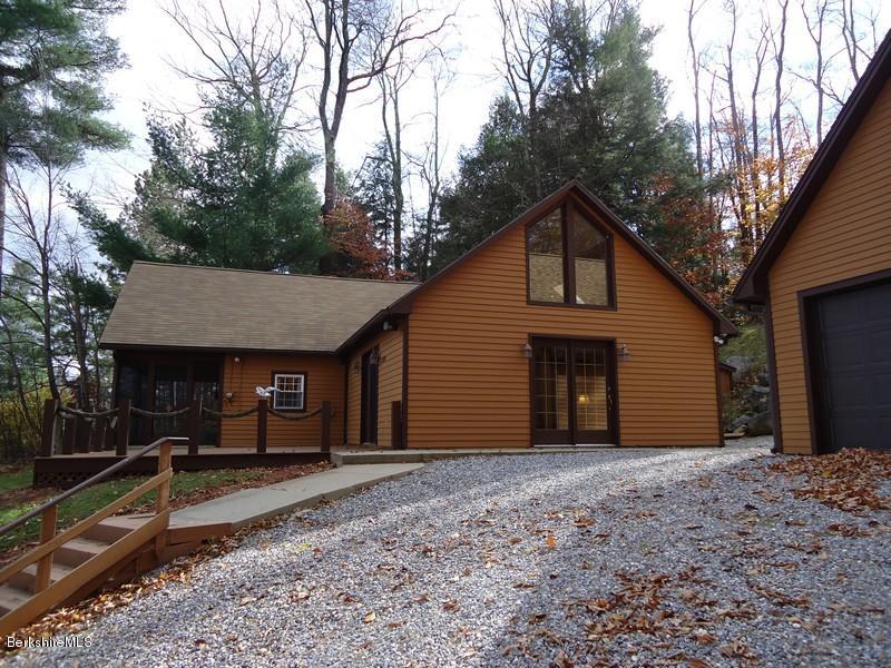 2359 North Main Road Otis, MA 01253 - Photo 1 of 32 a front view of house with yard and trees in the background