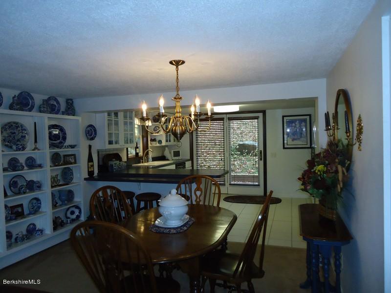 2359 North Main Road Otis, MA 01253 - Photo 15 of 32 a view of a dining room with furniture and chandelier