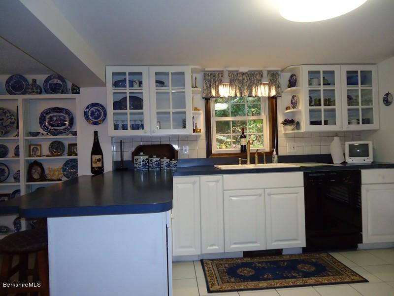 2359 North Main Road Otis, MA 01253 - Photo 18 of 32 a kitchen with stainless steel appliances granite countertop a stove and a microwave