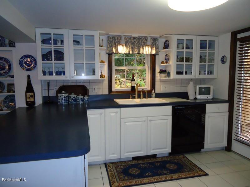 2359 North Main Road Otis, MA 01253 - Photo 20 of 32 a kitchen with a refrigerator and a stove