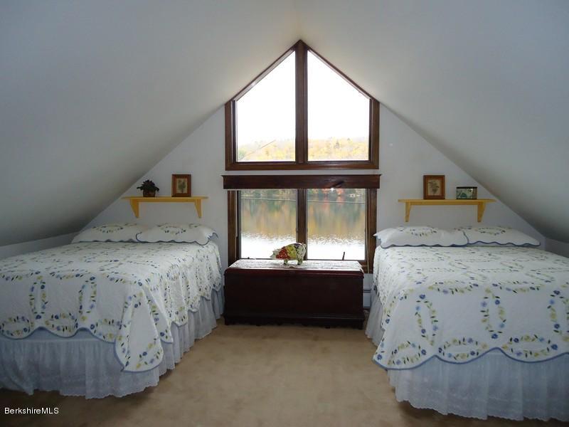 2359 North Main Road Otis, MA 01253 - Photo 21 of 32 a bed sitting in a bedroom next to a window